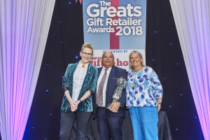 Above: Presenting John with the award was Henri Davies, (right), chairman of The Giftware Association, sponsors of the this category. Also shown is The Greats compere Pippa Evans.