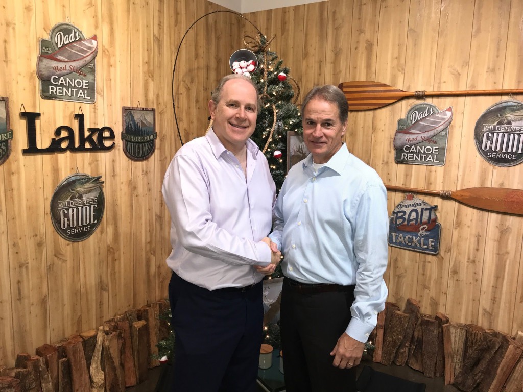 Above: Paul Fineman, ceo of Design Group, with Impact Innovation’s ceo John Dammermann shaking on the deal.