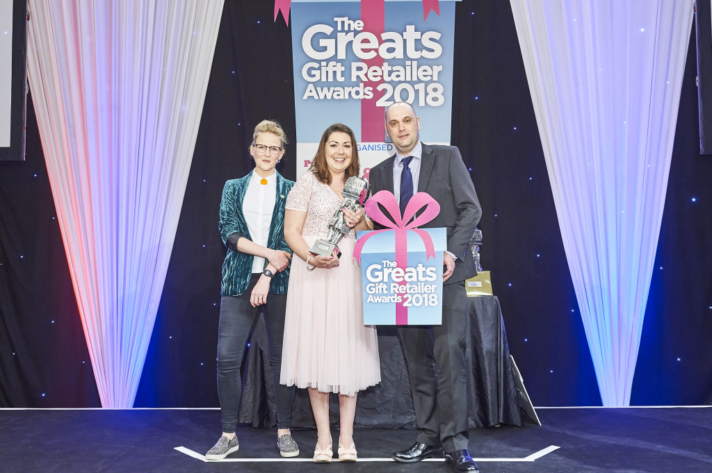 Above: At The Greats 2018, David Cree, sales manager at Joe Davies, presented Kate Everson, owner of The Gift Gallery in York, with her Greats trophy as winner of the Independent Gift Retailer of the Year North & Northern Ireland category. On the left is Greats compere Pippa Evans.