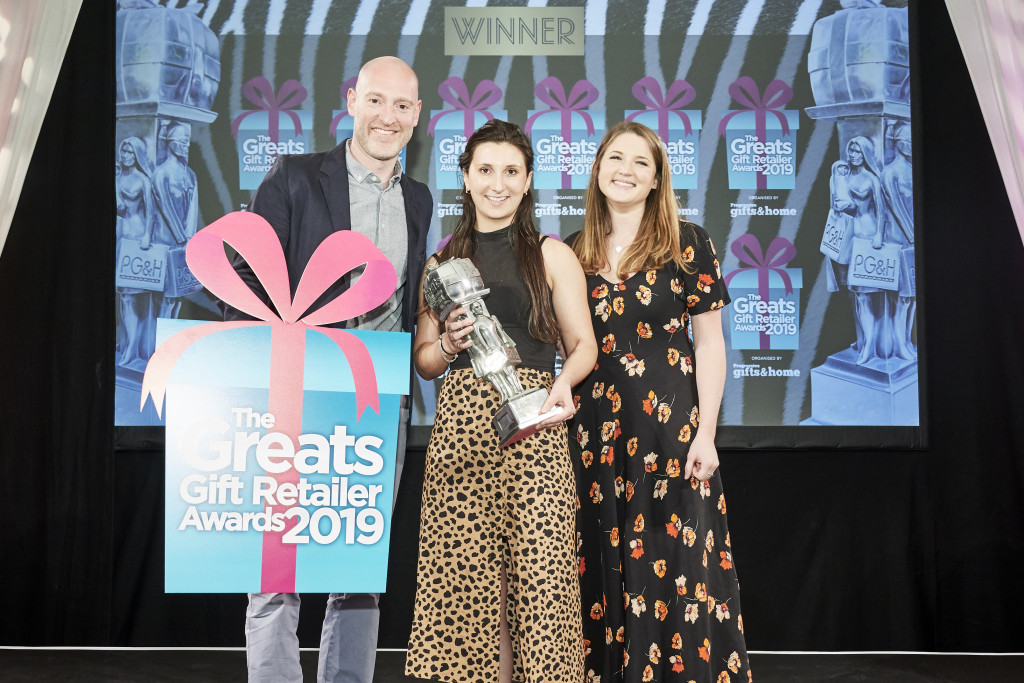 Above: Rosy Bick, (centre), assistant buyer at John Lewis &amp; Partners, received the Best Department Store Retailer of Gifts award, on behalf of the department store, from Mathilde Le Borgne, marketing manager of Brand Licensing Europe (BLE), category sponsors. On the left is Greats compere Henry Paker.