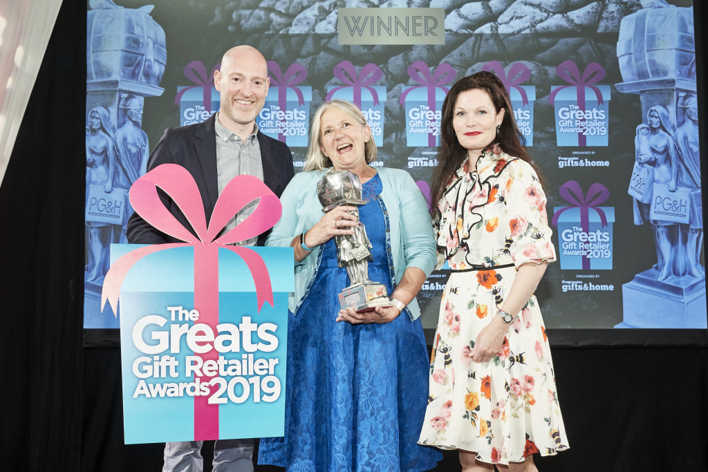 Above: A delighted Henri (centre) is shown on stage with Sarah Ward, chief executive of The Giftware Association (right) and Greats compere Henry Paker.