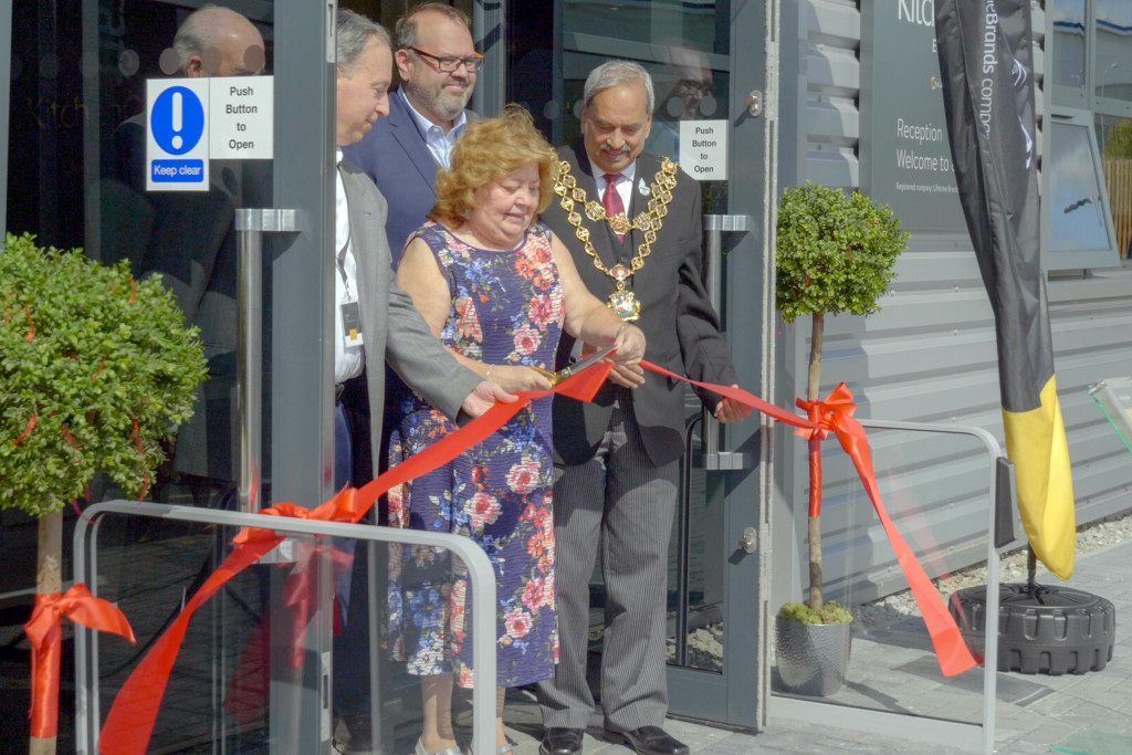 Above: Noreen Sweeney, sales office manager cuts the ribbon to open the new HQ.