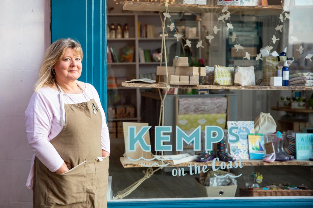 Above: Liz shows off the sycamore shelves at her Kemps on the Coast Whitby store which were created by Mark Bennett.