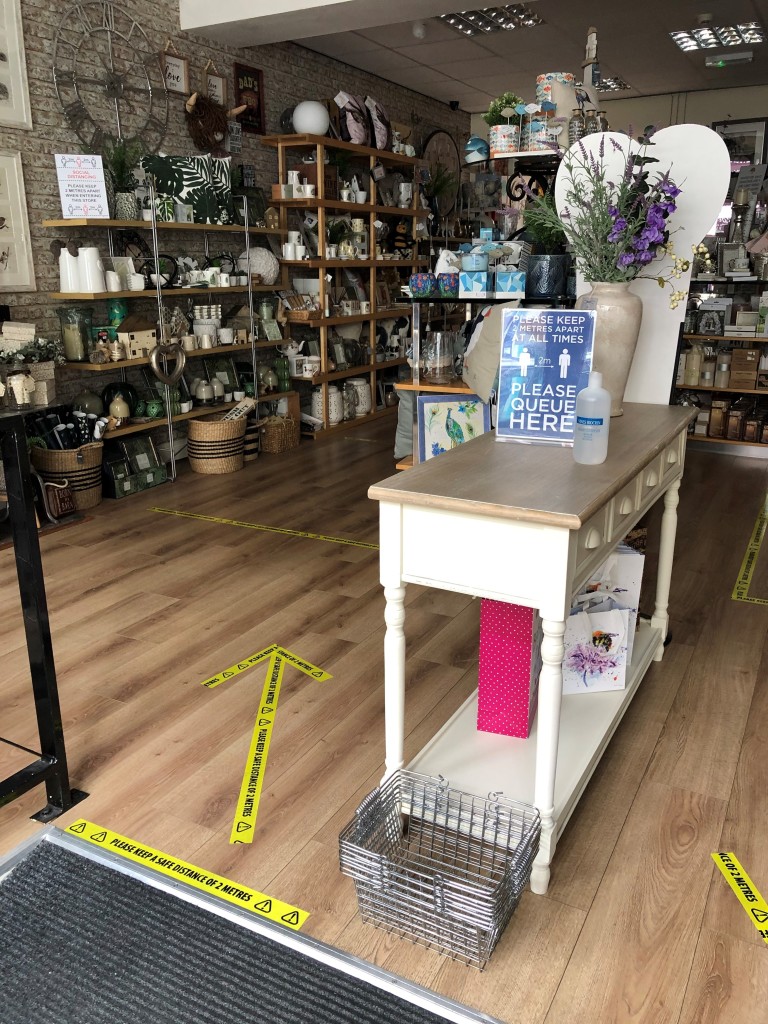 Above: Customers are being asked to use hand sanitiser as they enter the shop.