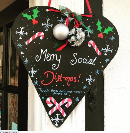 Above: The ‘Merry Social Dist-mas’ heart outside Buy The Light in Bury St Edmunds, with words courtesy of a Lanther Black Christmas card.