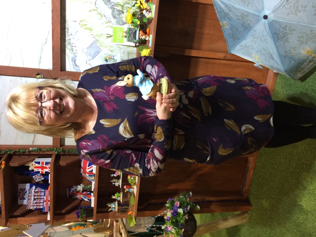 Above: Wendy Addison is shown with the commemorative Running Peter Rabbit figurine.