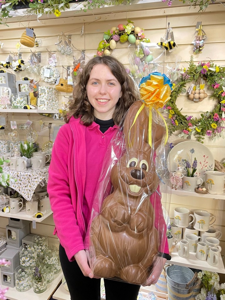 Above: Highworth Emporium Saturday girl Emily Milton holds the raffle prize of a 2.5 kilo chocolate bunny.