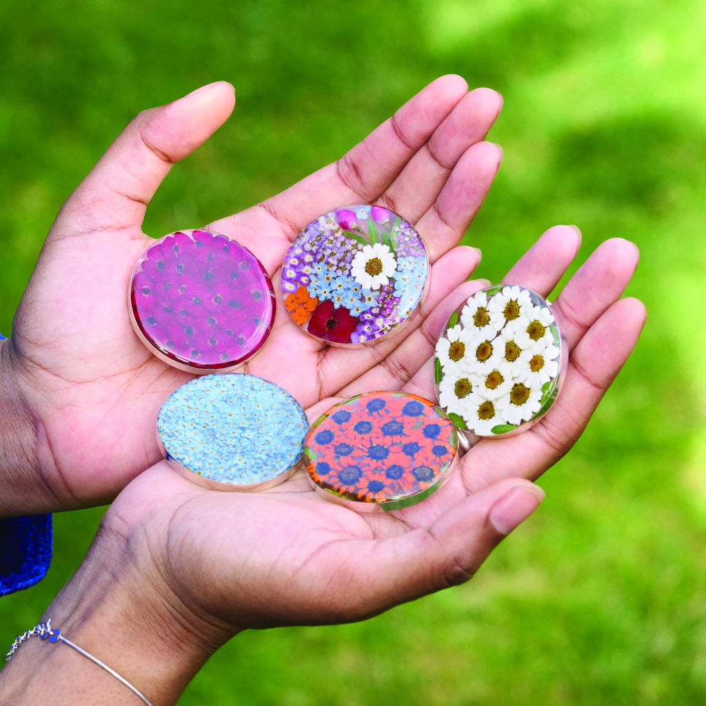 Above: A selection of Shrieking Violet brooches made from real flowers.