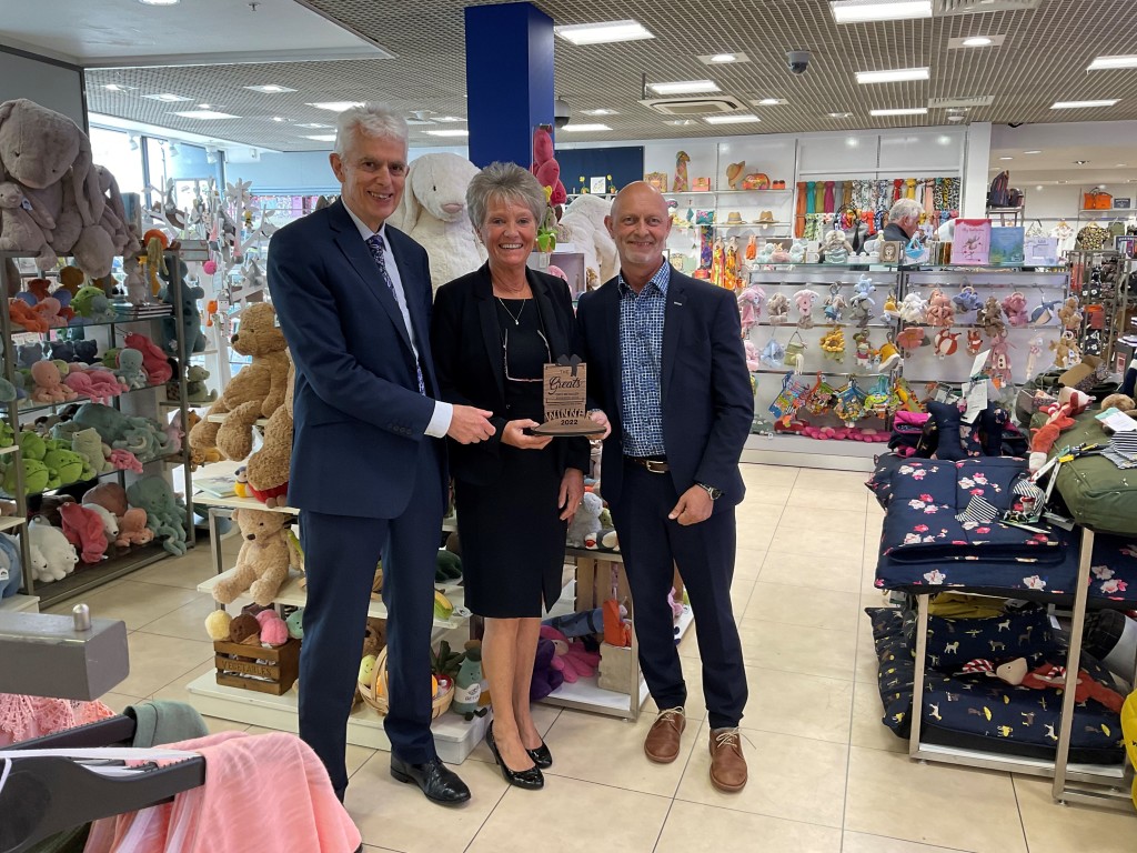 Above: From left to right: David Austin, owner of Austins, fashion manager Julie King, and merchandise director Paul Lewis, are shown with the coveted Greats trophy in May 2022.