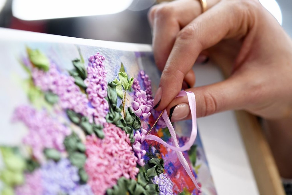 Above: A ribbon embroiderer at work.