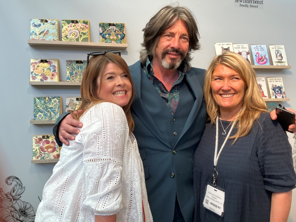 Above: Big smiles from Hugs and Kisses owner Caroline Ranwell (left) and buyer Amanda Logan-Evans who are shown with Laurence Llewelyn-Bowen on the GBCC stand. Laurence was there for the launch of his new card range.