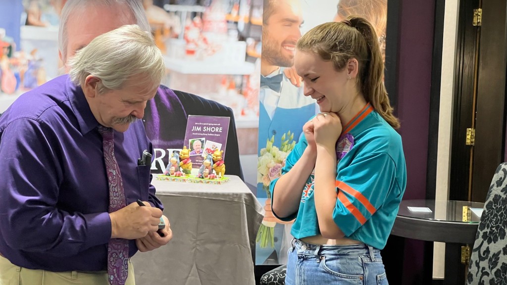 Above: A delighted fan gets her figurine signed.