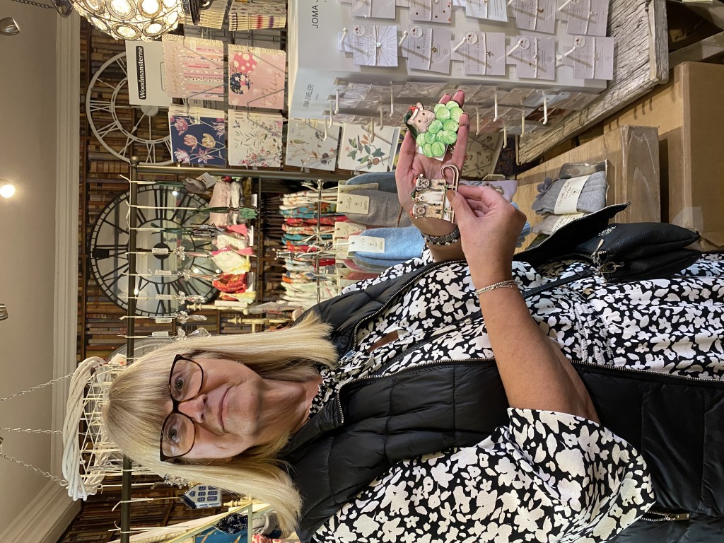 Above: Anne Barber is shown at In Heaven At Home in Market Harborough, holding Lottie Murphy wooden Christmas decorations.