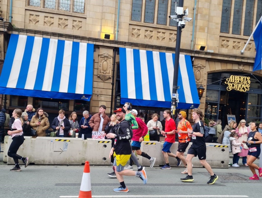 Above: The Giftware Association’s Chris Workman (in yellow shorts) is shown running in the Manchester Marathon earlier this month.